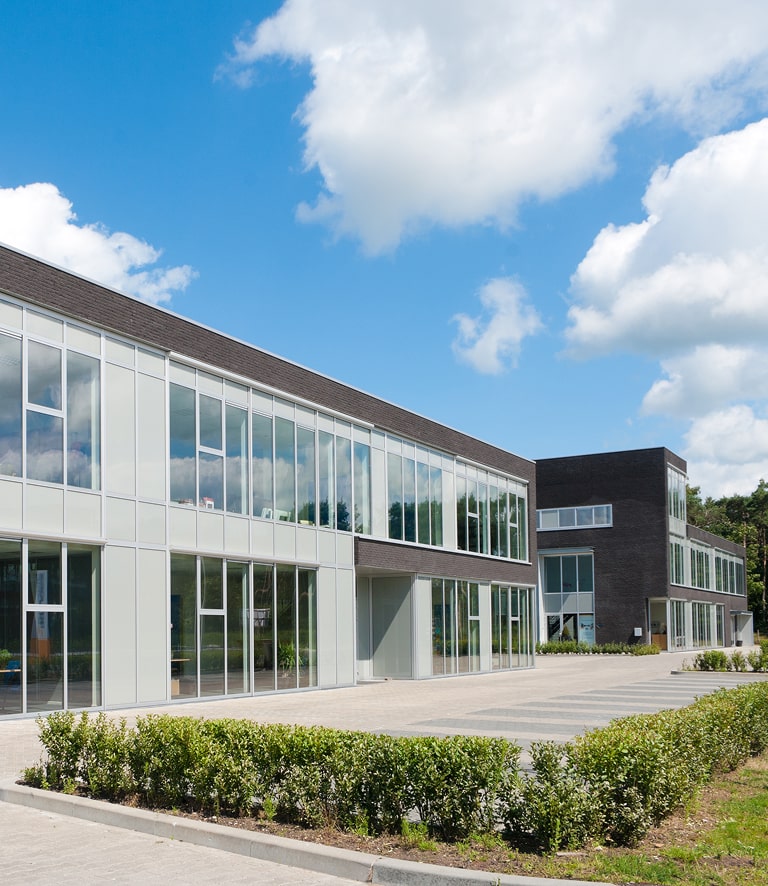 Modern office building with large windows and dark brick accents.